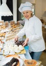 Young female seller offering sweets Royalty Free Stock Photo