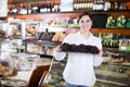 Seller offering tray of cakes