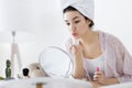 Young female after shower doing make up Royalty Free Stock Photo