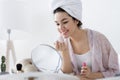 Young female after shower doing make up Royalty Free Stock Photo