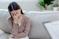 Young female sitting with her hands covering her face, feeling stressed and worried. Unhappy asian woman sitting alone. Sad women Royalty Free Stock Photo