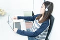 Young female sitting in living room and learning online Royalty Free Stock Photo