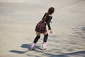 Young female skating in a outdoor skatepark in summer. Athletic person roller blading in a concrete urban park Royalty Free Stock Photo