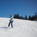 The young female skier in downhill slope.