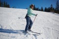 The young female skier in downhill slope.