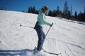 The young female skier in downhill slope.