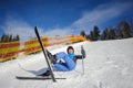 Young female skier after the fall on mountain slope Royalty Free Stock Photo