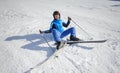 Young female skier after the fall on mountain slope Royalty Free Stock Photo