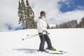 Young female skier skiing downhill at ski resort Royalty Free Stock Photo