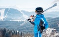 Young female skier with skiing equipment enjoying at winter ski resort in beautiful sunny day Royalty Free Stock Photo