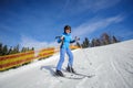 Young female skier on a sunny day at ski resort