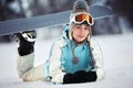 Young female snowboarder resting