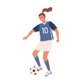 Young female soccer player kicking ball forward. Woman playing football in blue sports uniform, boots with studded sole