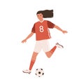 Young female soccer player running and kicking ball forward. Woman playing European football in red sports outfit, boots