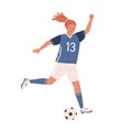 Young female soccer player running up and kicking ball forward. Woman playing football in blue sports uniform, boots and Royalty Free Stock Photo