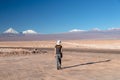Young female solo traveler walking in hiking trail at Atacama Desert. Single Blond Caucasian girl explore Moon Valley in Chile Royalty Free Stock Photo
