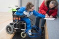 Young female sportswomen in wheelchairs prepare for competitions in the gym