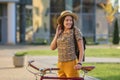 Young female student with backpack and books riding a retro bicycle.Female on retro bicycle. Royalty Free Stock Photo