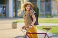 Young female student with backpack and books riding a retro bicycle.Female on retro bicycle. Royalty Free Stock Photo