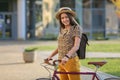 Young female student with backpack and books riding a retro bicycle.Female on retro bicycle. Royalty Free Stock Photo