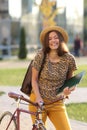 Young female student with backpack and books riding a retro bicycle. Female on retro bicycle. Royalty Free Stock Photo