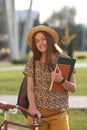 Young female student with backpack and books riding a retro bicycle. Female on retro bicycle. Royalty Free Stock Photo