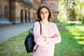 Young female student with backpack walking in the campus park Royalty Free Stock Photo