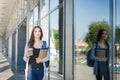 Young female IT student, with books and backpack. Going to lecture and drinking coffee Royalty Free Stock Photo