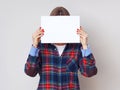 Young female student with empty piece of paper.