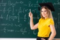 The young female student in front of the chalkboard Royalty Free Stock Photo