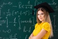 The young female student in front of the chalkboard Royalty Free Stock Photo