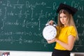 The young female student in front of the chalkboard Royalty Free Stock Photo