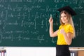 The young female student in front of the chalkboard Royalty Free Stock Photo