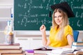 The young female student in front of the chalkboard Royalty Free Stock Photo