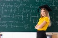 The young female student in front of the chalkboard Royalty Free Stock Photo