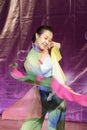 Young female student perform folding fan dance