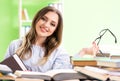 Young female student preparing for exams with many books Royalty Free Stock Photo