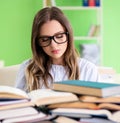 Young female student preparing for exams with many books Royalty Free Stock Photo