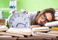 Young female student preparing for exams with many books in time Royalty Free Stock Photo