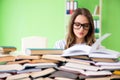 The young female student preparing for exams with many books Royalty Free Stock Photo