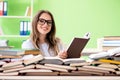 The young female student preparing for exams with many books Royalty Free Stock Photo