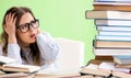 Young female student preparing for exams with many books Royalty Free Stock Photo