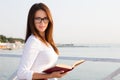 Young female student in reading glasses with the book Royalty Free Stock Photo