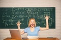 Young female student ready to write exam testing. Portrait of a happy female student using laptop computer in university Royalty Free Stock Photo