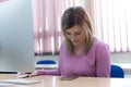 Young female student spending her time during lecture inside classroom in an international university