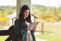 Young female student studying using tablet in college or private school outdoors, technology learning concept. Technology, Royalty Free Stock Photo