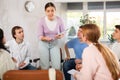 Young female student taking part in group discussion with coursemates Royalty Free Stock Photo