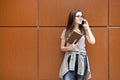 Young female student talking on the phone in outdoors. Royalty Free Stock Photo