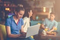 Young female student is using laptop computer in cafe Royalty Free Stock Photo
