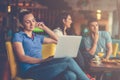 Young female student is using laptop computer in cafe Royalty Free Stock Photo